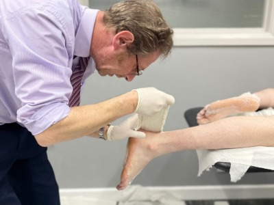 Janathan Stanly making a custom orthotic cast from a patient's foot