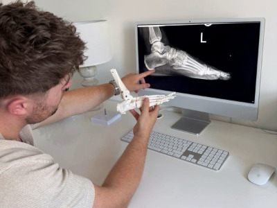 conor the podiatrist pointing to an xray