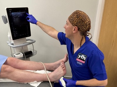 Scott the podiatrist using the ultra sound machine