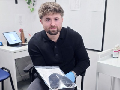 conor the podiatrist holding orthotics