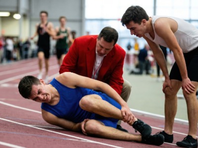 runner falling on track in pain